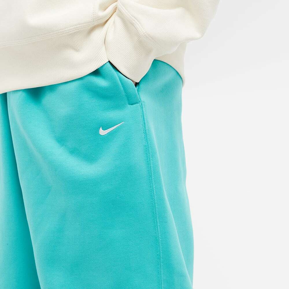 white nike shoes with teal swoosh